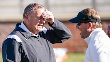 Arkansas Razorbacks coach Sam Pittman, left, talks with Missouri Tigers coach Eli Drinkwitz prior to a game at Faurot Field at Memorial Stadium.