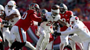 Nov 30, 2025; Tampa, Florida, USA; Arizona Cardinals running back Bam Knight (20) fumbles against Tampa Bay Buccaneers defensive tackle Vita Vea (50) during the first half at Raymond James Stadium. Mandatory Credit: Nathan Ray Seebeck-Imagn Images