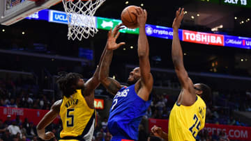 Mar 25, 2024; Los Angeles, California, USA; Los Angeles Clippers forward Kawhi Leonard (2) shoots against Indiana Pacers forward Jarace Walker (5) and forward Jalen Smith (25) during the second half at Crypto.com Arena. Mandatory Credit: Gary A. Vasquez-USA TODAY Sports