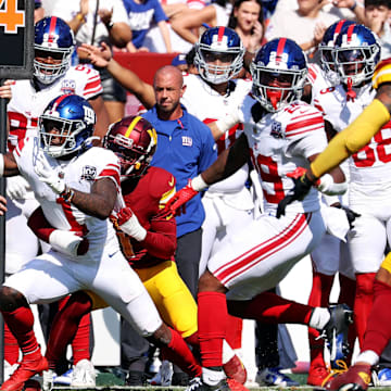 Sep 15, 2024; Landover, Maryland, USA; New York Giants wide receiver Malik Nabers (1) reaches for a first down during the fourth quarter against the Washington Commanders at Commanders Field.  