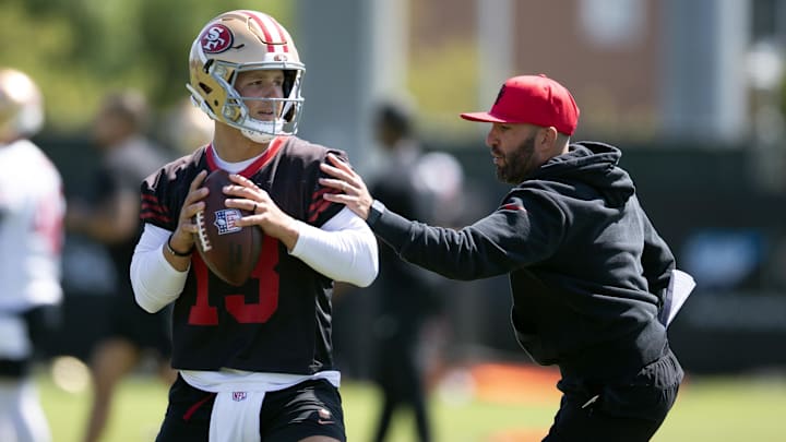 Jun 11, 2025; Santa Clara, CA, USA; San Francisco 49ers quarterbacks coach harasses Brock Purdy (13) in a passing drill during a team OTA at Levi's Stadium. Mandatory Credit: D. Ross Cameron-Imagn Images Jun 11, 2025; Santa Clara, CA, USA; San Francisco 49ers quarterbacks coach harasses Brock Purdy (13) in a passing drill during a team OTA at Levi's Stadium. Mandatory Credit: D. Ross Cameron-Imagn Images