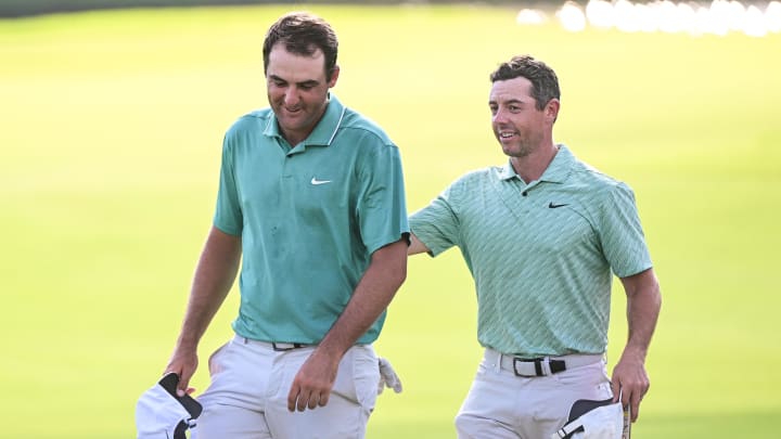 Aug 28, 2022; Atlanta, Georgia, USA; Scottie Scheffler and Rory McIlroy walk of the 18th green during the final round of the TOUR Championship golf tournament. Mandatory Credit: Adam Hagy-USA TODAY Sports