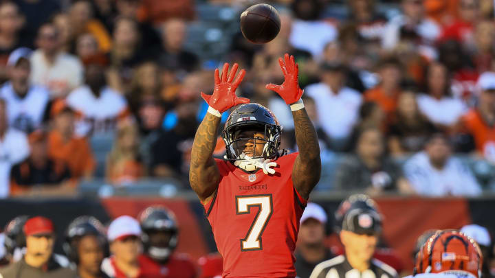 Aug 10, 2024; Cincinnati, Ohio, USA; Tampa Bay Buccaneers running back Bucky Irving (7) catches a pass against Cincinnati Bengals safety Vonn Bell (24) in the first half at Paycor Stadium. Mandatory Credit: Katie Stratman-USA TODAY Sports