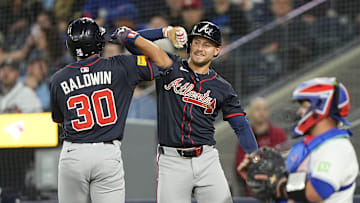 Apr 16, 2025; Toronto, Ontario, CAN; Atlanta Braves right fielder Jarred Kelenic (24) congratulates right fielder Drake Baldwin (30) on his solo home run as Toronto Blue Jays catcher Alejandro Kirk (30) looks on during the ninth inning at Rogers Centre. Mandatory Credit: John E. Sokolowski-Imagn Images