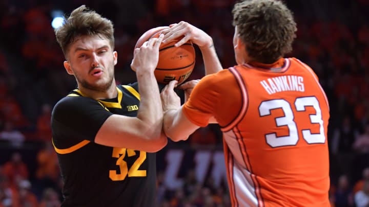 Feb 24, 2024; Champaign, Illinois, USA; Illinois Fighting Illini forward Coleman Hawkins (33) and Iowa Hawkeyes forward Owen Freeman (32) wrestle for a rebound during the second half at State Farm Center. Mandatory Credit: Ron Johnson-USA TODAY Sports