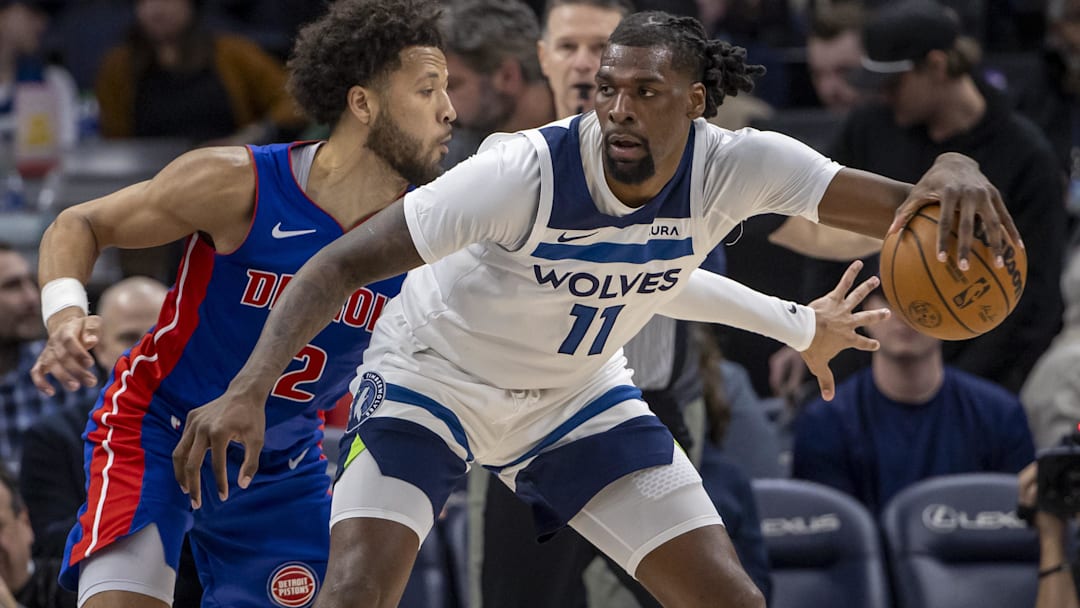 Minnesota Timberwolves center Naz Reid (11) backs toward the basket and keeps the ball away from Detroit Pistons guard Cade Cunningham (2) in the second half at Target Center.