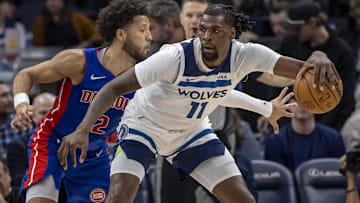 Minnesota Timberwolves center Naz Reid (11) backs toward the basket and keeps the ball away from Detroit Pistons guard Cade Cunningham (2) in the second half at Target Center.