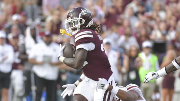 Mississippi State Bulldogs running back Davon Booth (21) runs the ball against Massachusetts Minutemen linebacker.