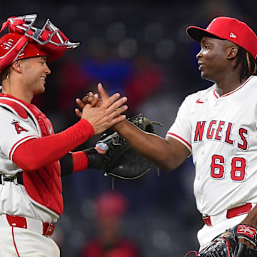 May 6, 2025; Anaheim, California, USA; Los Angeles Angels catcher Logan O'Hoppe (14) and pitcher Jose Fermin (68) celebrate the victory against the Toronto Blue Jays at Angel Stadium. Mandatory Credit: Gary A. Vasquez-Imagn Images
