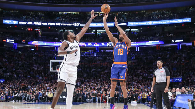Mar 23, 2024; New York, New York, USA;  New York Knicks guard Alec Burks (18) takes a three point shot past Brooklyn Nets center Day'Ron Sharpe (20) in the third quarter at Madison Square Garden. Mandatory Credit: Wendell Cruz-USA TODAY Sports