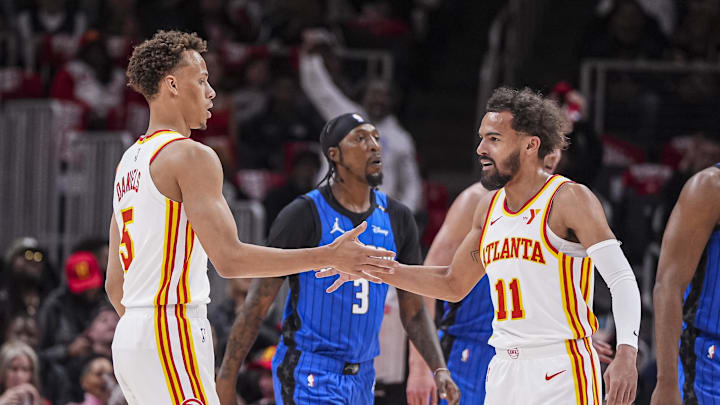 Atlanta Hawks guard Dyson Daniels and guard Trae Young react after combining for a basket against the Orlando Magic during the first half at State Farm Arena.