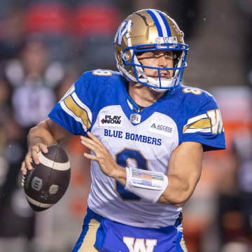 Jun 13, 2024; Ottawa, Ontario, CAN; Winnipeg Blue Bombers quarteback Zach Collards (8) holds the ball in the first hald against the Ottawa REDBLACKS at TD Place. Mandatory Credit: Marc DesRosiers-USA TODAY Sports