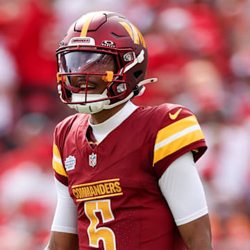 Sep 8, 2024; Tampa, Florida, USA; Washington Commanders quarterback Jayden Daniels (5) looks on against the Tampa Bay Buccaneers in the first quarter at Raymond James Stadium. Mandatory Credit: Nathan Ray Seebeck-Imagn Images