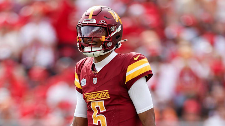 Sep 8, 2024; Tampa, Florida, USA; Washington Commanders quarterback Jayden Daniels (5) looks on against the Tampa Bay Buccaneers in the first quarter at Raymond James Stadium. Mandatory Credit: Nathan Ray Seebeck-Imagn Images