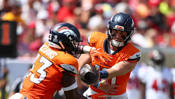 Sep 22, 2024; Tampa, Florida, USA; Denver Broncos quarterback Bo Nix (10) hands off to running back Javonte Williams (33) against the Tampa Bay Buccaneers in the first quarter at Raymond James Stadium. Mandatory Credit: Nathan Ray Seebeck-Imagn Images