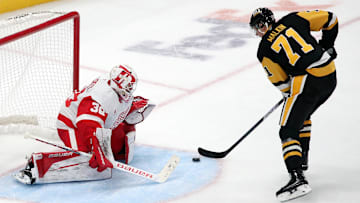 Nov 13, 2024; Pittsburgh, Pennsylvania, USA;  Detroit Red Wings goaltender Cam Talbot (39) defends the net against Pittsburgh Penguins center Evgeni Malkin (71) in overtime at PPG Paints Arena. Mandatory Credit: Charles LeClaire-Imagn Images