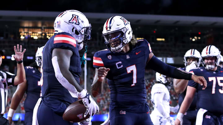 Sep 2, 2023; Tucson, Arizona, USA; Arizona Wildcats quarterback Jayden de Laura (7) celebrates a touchdown with running back Jonah Coleman (3) against the Northern Arizona Lumberjacks during the first half at Arizona Stadium.