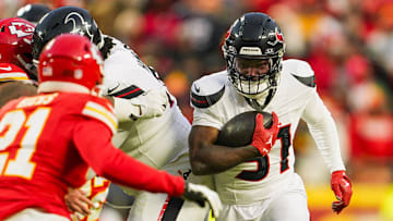 Jan 18, 2025; Kansas City, Missouri, USA; Houston Texans running back Dameon Pierce (31) runs the ball against Kansas City Chiefs safety Jaden Hicks (21) during the second half in a 2025 AFC divisional round game at GEHA Field at Arrowhead Stadium. Mandatory Credit: Jay Biggerstaff-Imagn Images