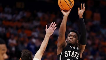 Mississippi State Bulldogs guard Josh Hubbard (13) shoots a basket over the reach of Tennessee Volunteers guard Santiago Vescovi (25) during their quarterfinal game of the SEC Men's Basketball Tournament at Bridgestone Arena in Nashville, Tenn., Friday, March 15, 2024.