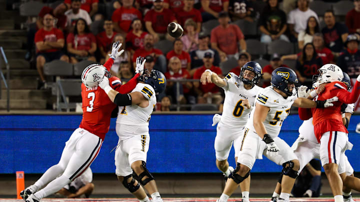 Sep 7, 2024; Tucson, Arizona, USA; Arizona Lumberjacks quarterback Ty Pennington (6) throws the ball against Arizona Wildcats defensive lineman Tre Smith (3) during first quarter at Arizona Stadium. Mandatory Credit: Aryanna Frank-Imagn Images