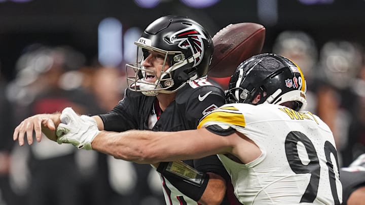 Sep 8, 2024; Atlanta, Georgia, USA; Pittsburgh Steelers linebacker T.J. Watt (90) strips the ball from Atlanta Falcons quarterback Kirk Cousins (18) at Mercedes-Benz Stadium. 