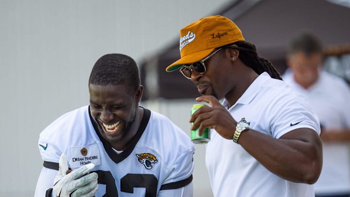 Jacksonville Jaguars linebacker Foyesade Oluokun (23) and former Jaguar Johnathan Cyprien, right, have a laugh with a fellow NFL player Kemal Ishmael, on the phone after the Jacksonville Jaguars’ third mandatory minicamp Thursday June 12, 2025 at the Miller Electric Center in Jacksonville, Fla. [Doug Engle/Florida Times-Union]