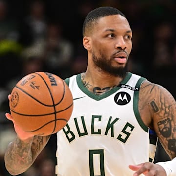 Mar 13, 2025; Milwaukee, Wisconsin, USA; Milwaukee Bucks guard Damian Lillard (0) dribbles the ball against the Los Angeles Lakers in the first quarter at Fiserv Forum. The Bucks wore a small patch to honor former player Junior Bridgeman who passed away this week.  Mandatory Credit: Benny Sieu-Imagn Images