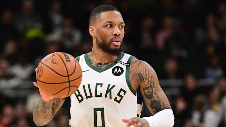 Mar 13, 2025; Milwaukee, Wisconsin, USA; Milwaukee Bucks guard Damian Lillard (0) dribbles the ball against the Los Angeles Lakers in the first quarter at Fiserv Forum. The Bucks wore a small patch to honor former player Junior Bridgeman who passed away this week.  Mandatory Credit: Benny Sieu-Imagn Images