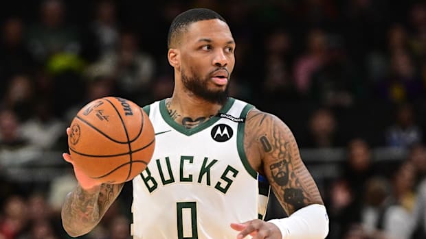 Milwaukee Bucks guard Damian Lillard (0) dribbles the ball against the Los Angeles Lakers.