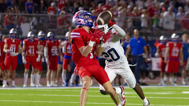Westlake's Lawson Grimes (1) catches a TD over Atascosita's Amare Banks (20) in a ranked football tilt on Sept 13, 2024.