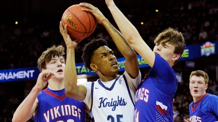 Nicolet's Davion Hannah (25) is guarded by Wisconsin Lutheran's Trey Raabe (14) and Zavier Zens (23) during the first half of the WIAA Division 2 boys basketball state semifinal game on Friday March 15, 2024 at the Kohl Center in Madison, Wis.