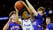 Nicolet's Davion Hannah (25) is guarded by Wisconsin Lutheran's Trey Raabe (14) and Zavier Zens (23) during the first half of the WIAA Division 2 boys basketball state semifinal game on Friday March 15, 2024 at the Kohl Center in Madison, Wis.
