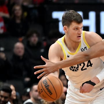 Mar 7, 2025; Toronto, Ontario, CAN;  Utah Jazz center Walker Kessler (24) looks to make a pass as Toronto Raptors center Orlando Robinson (21) defends in the first half at Scotiabank Arena. Mandatory Credit: Dan Hamilton-Imagn Images