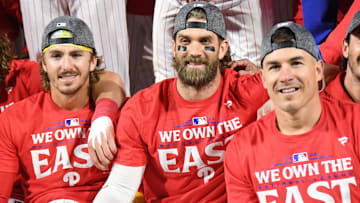  Philadelphia Phillies second base Bryson Stott (5), first baseman Bryce Harper (3) and catcher J.T. Realmuto (10) celebrate the National League East Division title at Citizens Bank Park.