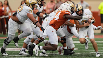 Nov 1, 2025; Austin, Texas, USA; Vanderbilt Commodores quarterback Diego Pavia (2) is tackled by Texas Longhorns defensive lineman Brad Spence (14).