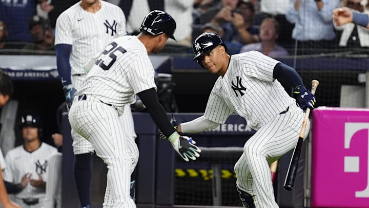 Sep 12, 2024; Bronx, New York, USA; New York Yankees right fielder Juan Soto (22) congratulated New York Yankees second baseman Gleyber Torres (25) for hitting a home run against the Boston Red Sox during the first inning at Yankee Stadium.