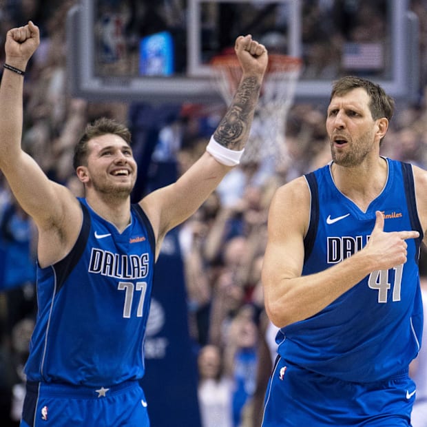 Dallas Mavericks forward Dirk Nowitzki and forward Luka Doncic celebrate during the game against the Phoenix Suns. 