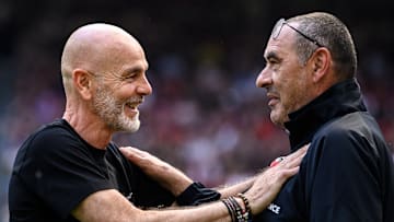 Stefano Pioli (L), head coach of AC Milan, speaks with...