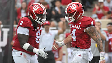 Indiana Hoosiers defensive lineman CJ West (8) and linebacker Aiden Fisher (4) celebrate after a defensive stop against the Maryland Terrapins during the first half at Memorial Stadium.