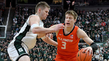 Jan 19, 2025; East Lansing, Michigan, USA;  Michigan State Spartans forward Jaxon Kohler (0) defends Illinois Fighting Illini forward Ben Humrichous (3) during the first half at Jack Breslin Student Events Center. Mandatory Credit: Dale Young-Imagn Images