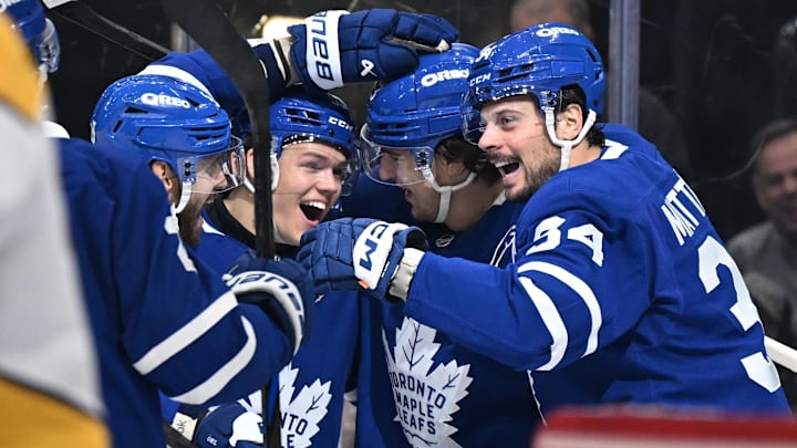 Oct 14, 2025; Toronto, Ontario, CAN;  Toronto Maple Leafs forward Auston Matthews (34) celebrates with forwards Easton Cowan (53) and Matthew Knies (23) and defenseman Oliver Ekman-Larsson (95) after scoring a goal against the Nashville Predators in the third period at Scotiabank Arena. Mandatory Credit: Dan Hamilton-Imagn Images