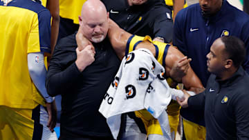 Jun 22, 2025; Oklahoma City, Oklahoma, USA; Indiana Pacers guard Tyrese Haliburton (0) is assisted after an apparent injury following a play against the Oklahoma City Thunder during the first half of game seven of the 2025 NBA Finals at Paycom Center. Mandatory Credit: Alonzo Adams-Imagn Images