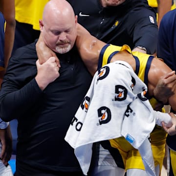 Jun 22, 2025; Oklahoma City, Oklahoma, USA; Indiana Pacers guard Tyrese Haliburton (0) is assisted after an apparent injury following a play against the Oklahoma City Thunder during the first half of game seven of the 2025 NBA Finals at Paycom Center. Mandatory Credit: Alonzo Adams-Imagn Images