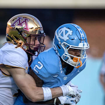 Sep 16, 2023; Chapel Hill, North Carolina, USA; North Carolina Tar Heels wide receiver Gavin Blackwell (2) catches the ball as Minnesota Golden Gophers defensive back Aidan Gousby (7) defends in the third quarter at Kenan Memorial Stadium. 