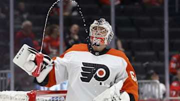 Sep 22, 2024; Washington, District of Columbia, USA; Philadelphia Flyers goaltender Carson Bjarnason (64) watches water squirted from his bottle during a timeout against the Washington Capitals in the third period at Capital One Arena.