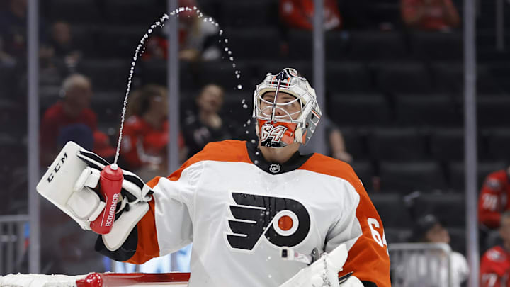Sep 22, 2024; Washington, District of Columbia, USA; Philadelphia Flyers goaltender Carson Bjarnason (64) watches water squirted from his bottle during a timeout against the Washington Capitals in the third period at Capital One Arena. Mandatory Credit: Geoff Burke-Imagn Images