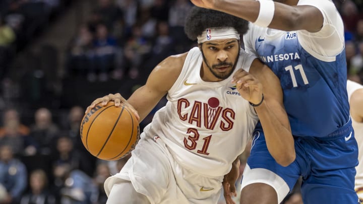 Mar 22, 2024; Minneapolis, Minnesota, USA; Cleveland Cavaliers center Jarrett Allen (31) drives to the basket as Minnesota Timberwolves center Naz Reid (11) plays defense in the first half at Target Center. Mandatory Credit: Jesse Johnson-USA TODAY Sports