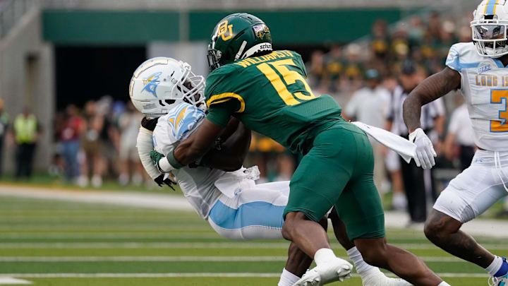 Sep 16, 2023; Waco, Texas, USA; Long Island Sharks running back Pat Bowen (4) is tackled by Baylor Bears cornerback Carl Williams IV (15) during the first half at McLane Stadium. Mandatory Credit: Chris Jones-Imagn Images Sep 16, 2023; Waco, Texas, USA; Long Island Sharks running back Pat Bowen (4) is tackled by Baylor Bears cornerback Carl Williams IV (15) during the first half at McLane Stadium. Mandatory Credit: Chris Jones-Imagn Images