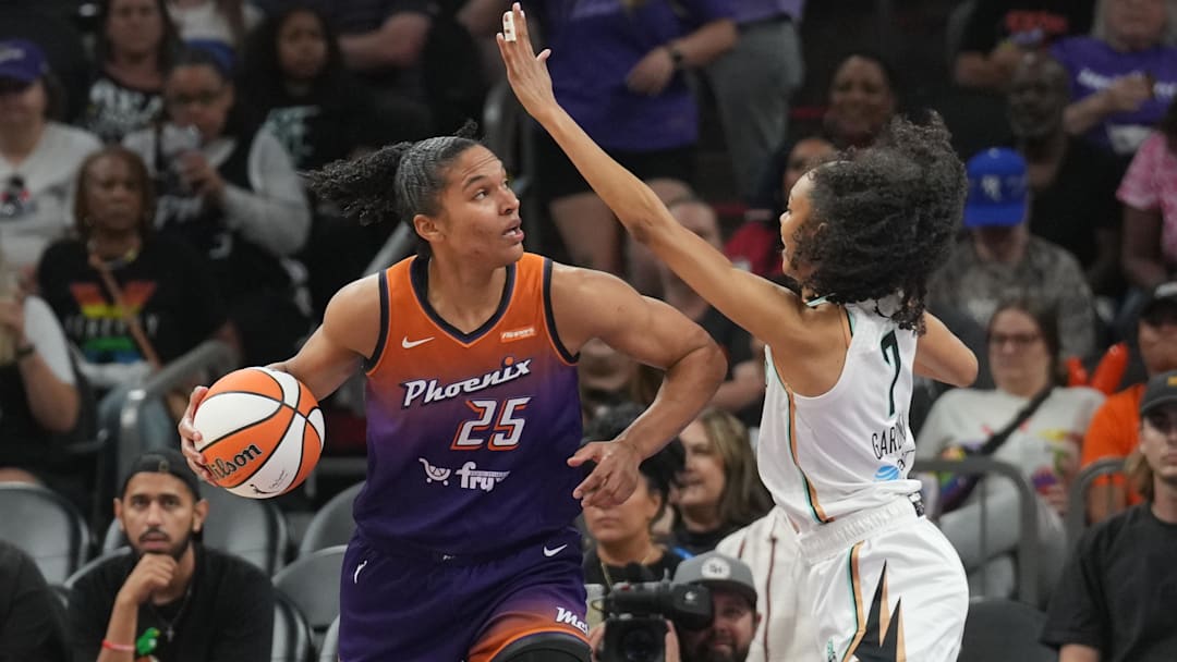 Jun 27, 2025; Phoenix, Arizona, USA; Phoenix Mercury forward Alyssa Thomas (25) dribbls against New York Liberty guard Rebekah Gardner (7) during the second half at Footprint Center. Mandatory Credit: Joe Camporeale-Imagn Images