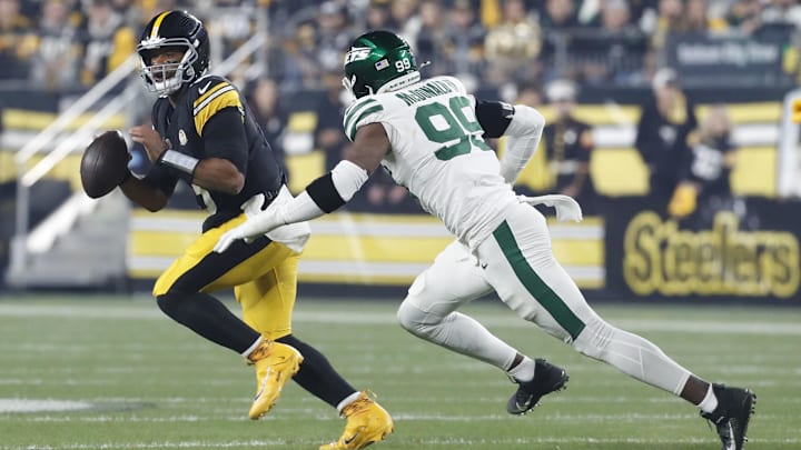 Oct 20, 2024; Pittsburgh, Pennsylvania, USA; Pittsburgh Steelers quarterback Russell Wilson (3) scrambles against pressure from New York Jets defensive end Will McDonald IV (99) during the first quarter at Acrisure Stadium. Mandatory Credit: Charles LeClaire-Imagn Images Oct 20, 2024; Pittsburgh, Pennsylvania, USA; Pittsburgh Steelers quarterback Russell Wilson (3) scrambles against pressure from New York Jets defensive end Will McDonald IV (99) during the first quarter at Acrisure Stadium. Mandatory Credit: Charles LeClaire-Imagn Images